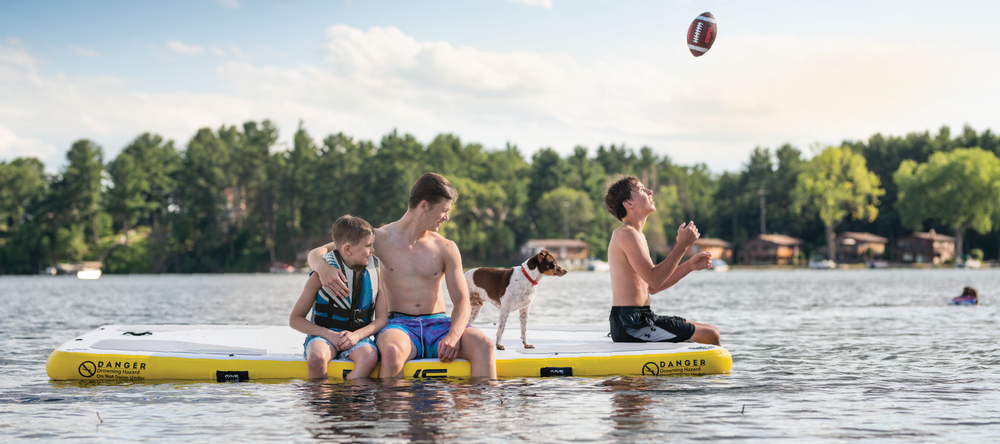 three boys and dog on RAVE Sports Aqua Dock 10x10