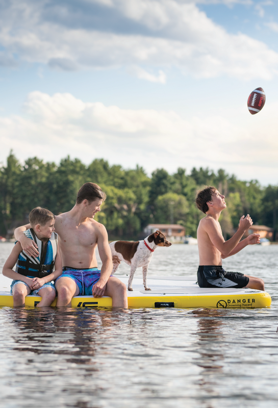 three boys and dog on RAVE Sports Aqua Dock 10x10