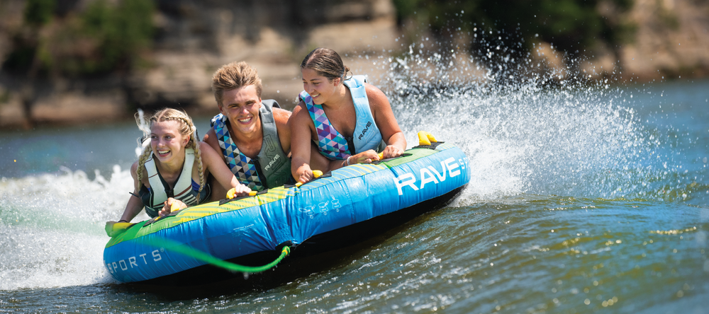 Three riders on a RAVE Sports GOAT boat towable tube